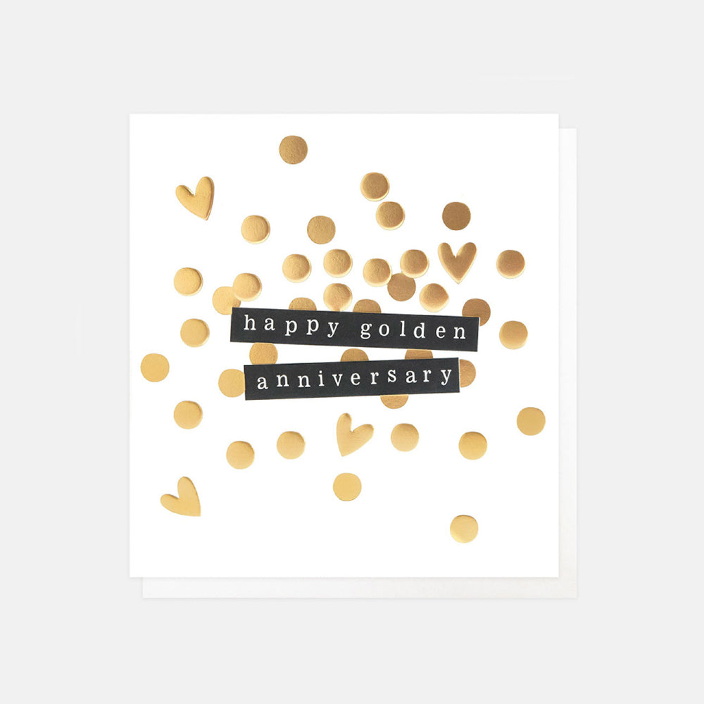 A square white greeting card with scattered gold confetti hearts and circles and two black horizontal banners reading 'happy golden anniversary' in white text, shown on a light gray background.