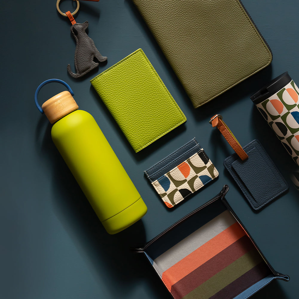 caroline gardner men's collection featuring water bottle, travel coffee cup, wallet, luggage tag and key tray