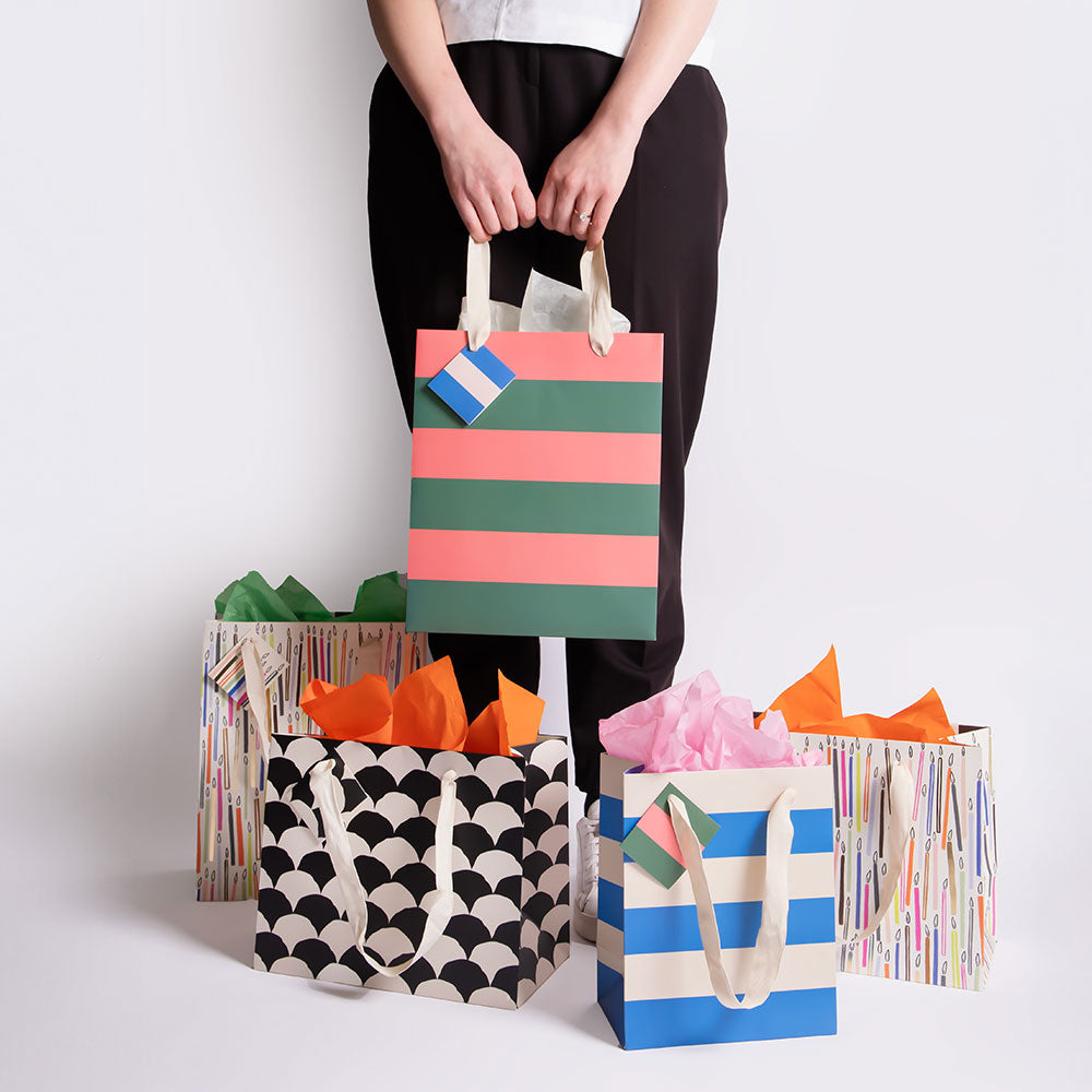 colourful candles and stripes gift bags