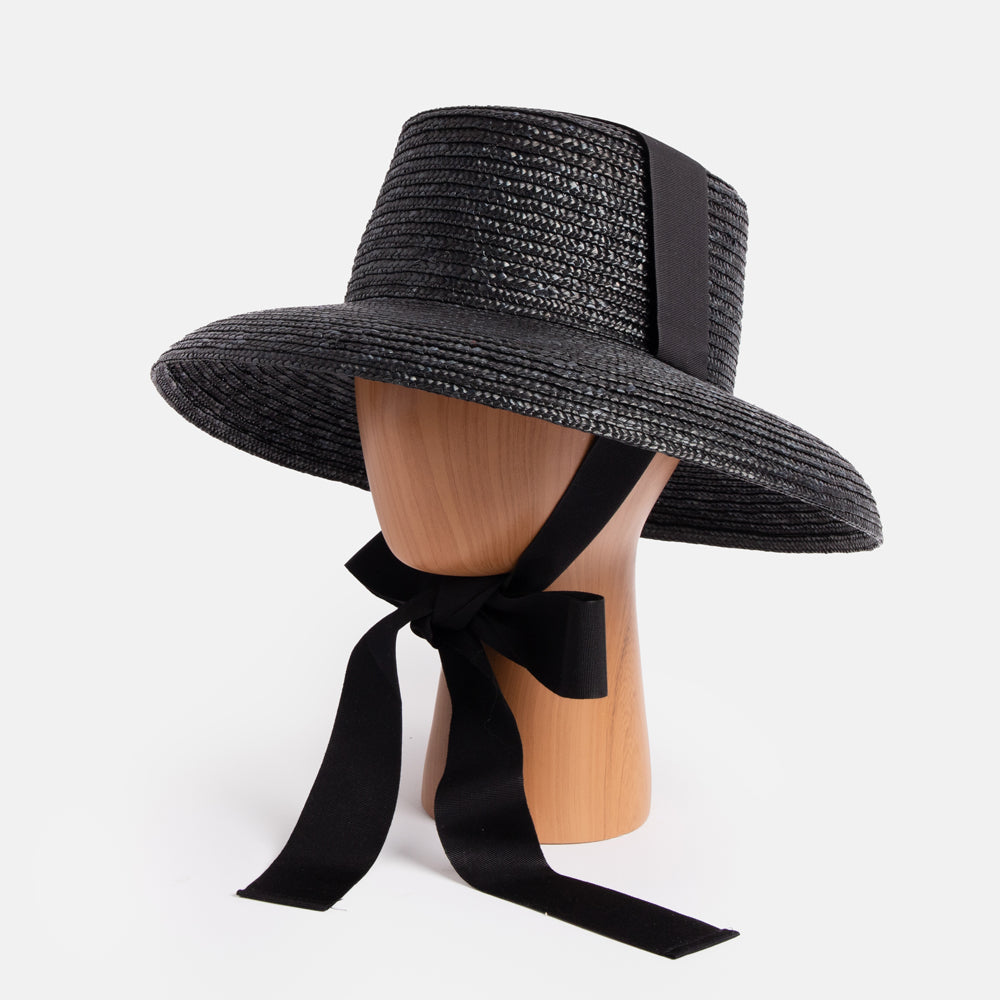 large black straw hat with black ribbon ties, hand made in Italy