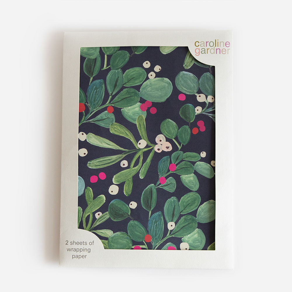 pack of 2 sheets of Christmas wrapping paper featuring a design of mistletoe and berries