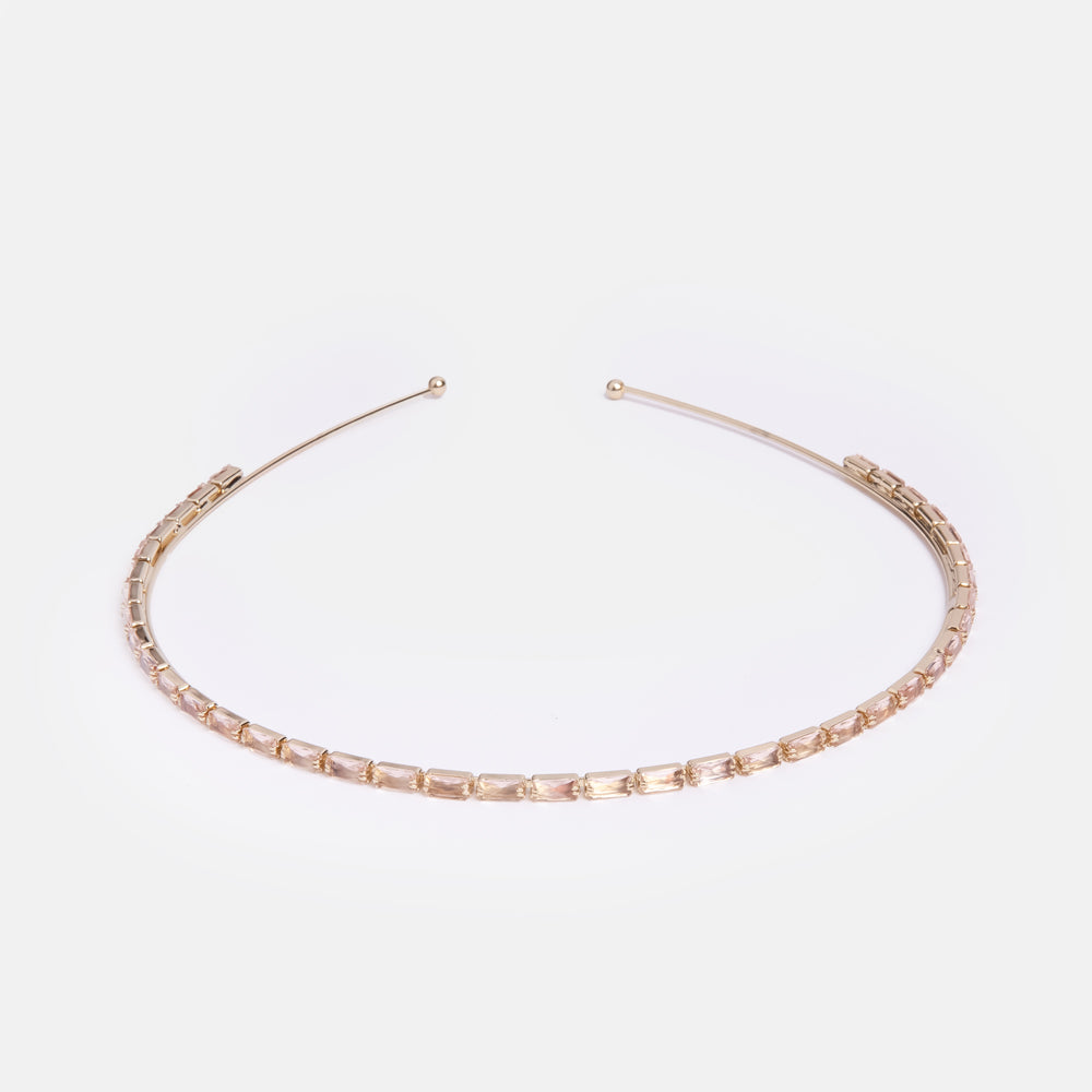 thin gold headband with pale peach crystals set along 