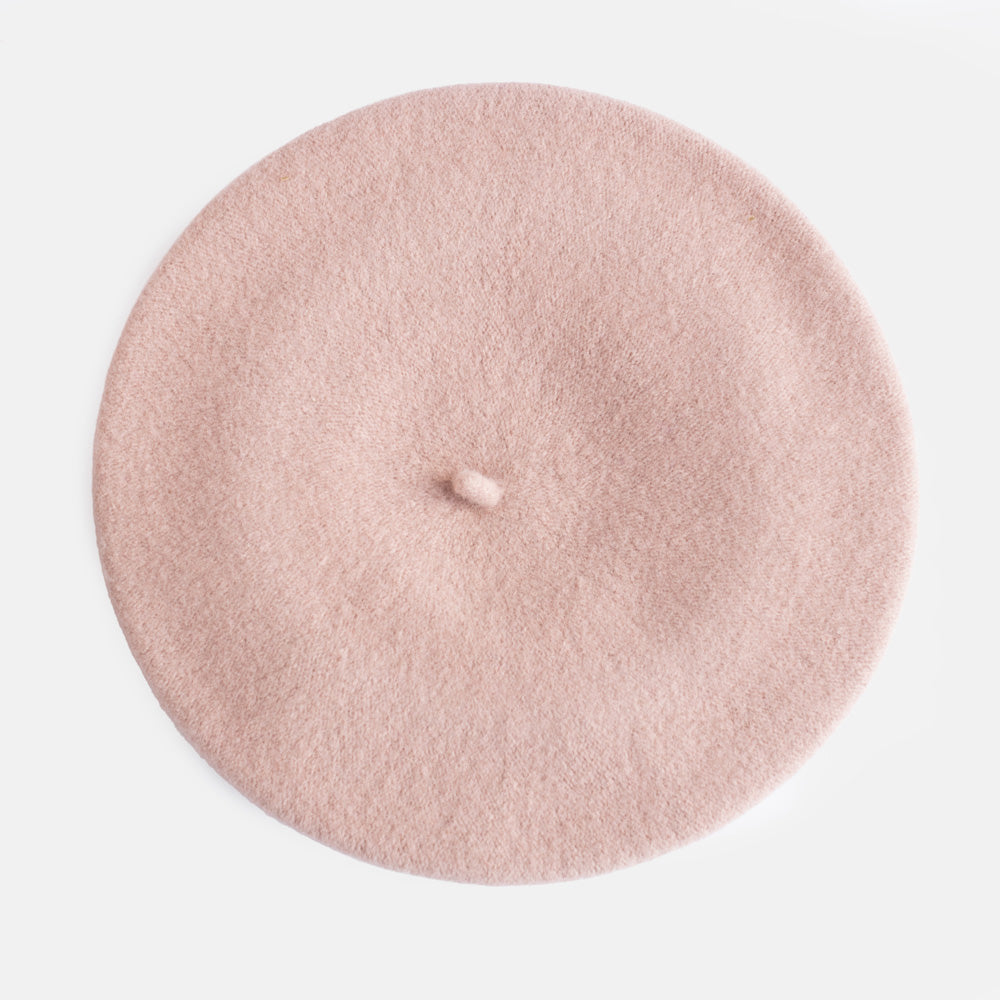 A dusty pink felt beret hat photographed from directly above on a clean white background.