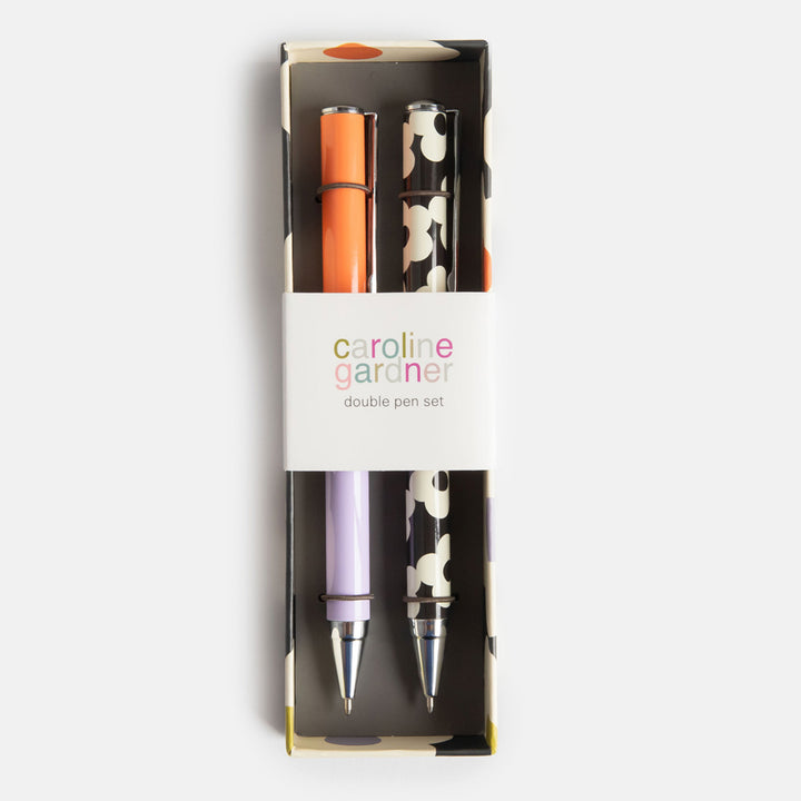 set of 2 boxed ballpoint pens, one in block lilac & coral, the other in monochrome flowers print