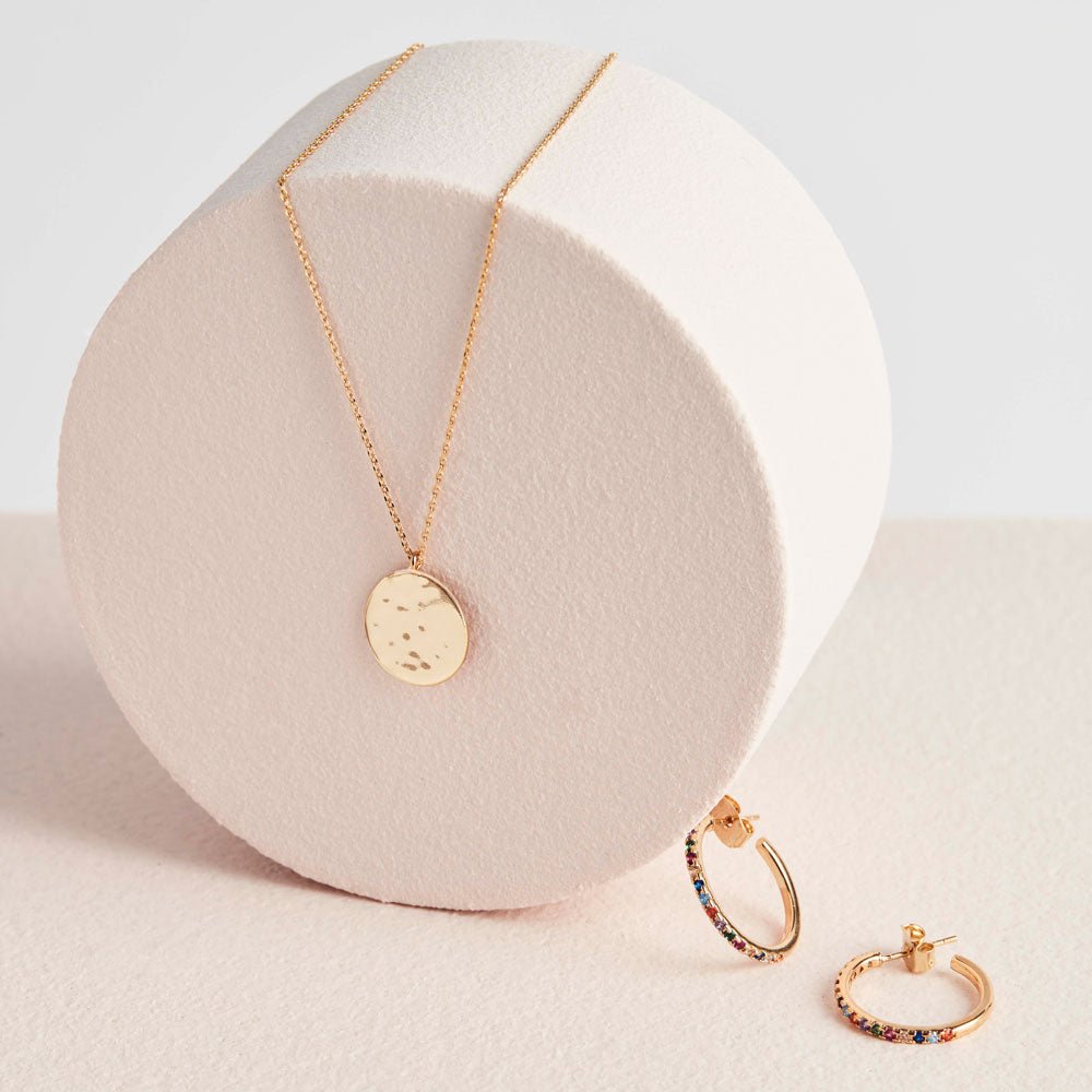 hammered disc gold pendant necklace with gemstone gold earrings